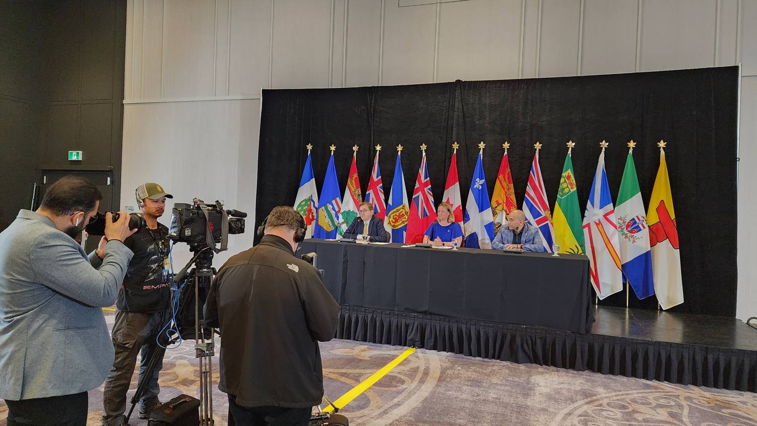 Multilingual press conference with broadcast cameras